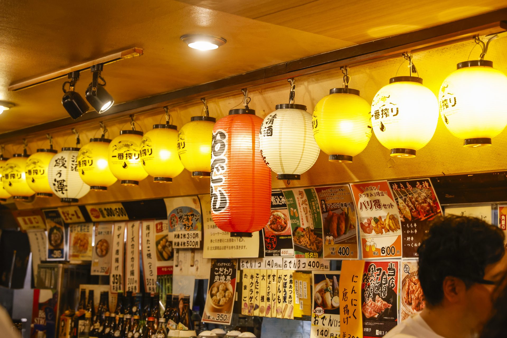 Japanese lanterns and handwritten menus inside a local izakaya